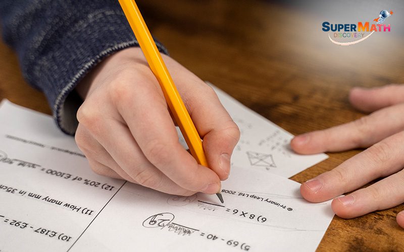 Student completing a Primary 5 math worksheet.