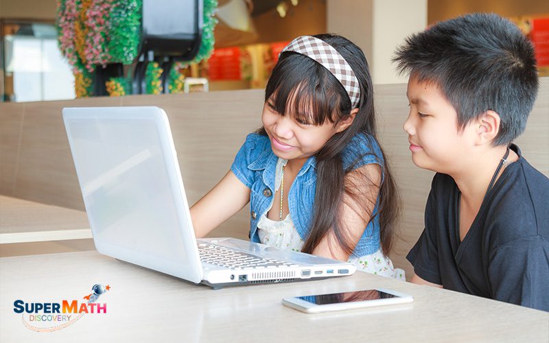 Students using a laptop for game-based learning.