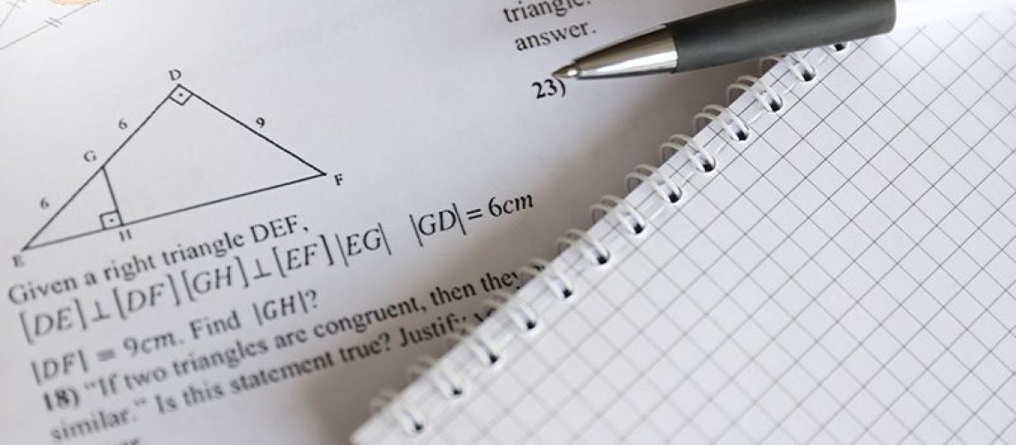 Math exam on a paper with pen.